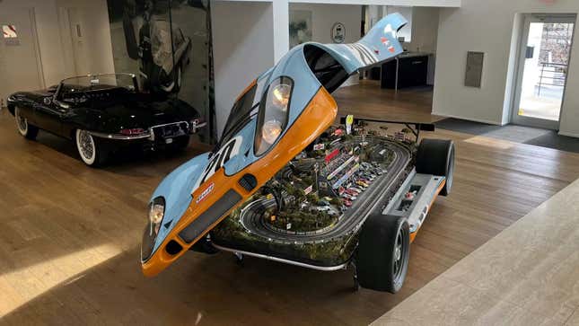 A photo of a Porsche 917 body with a slot car track inside. 