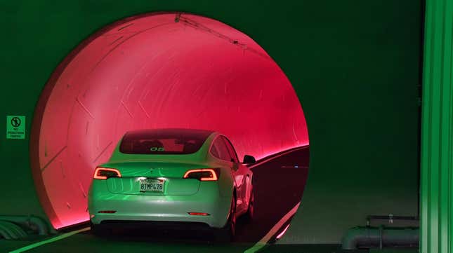 A Tesla car drives through a tunnel in the Central Station during a media preview of the Las Vegas Convention Center Loop on April 9, 2021 in Las Vegas, Nevada.